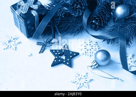 Classic blue 2020. Gradient color palette. Christmas, new year concept background. Branches of spruce and decorations. Stock Photo