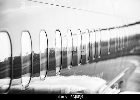 Close up on the fuselage of the commercial airplane, jetliner body casing. Stock Photo