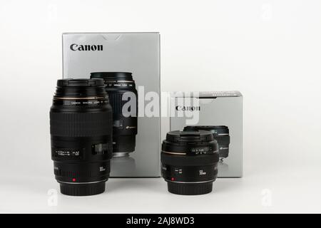 Brnenec, Czech Republic-August 13, 2019:  Two  lens Canon EF 100 mm f 2,8 and Canon EF 50 mm f 1,4 with boxes  on white background. Canon is Japanese Stock Photo