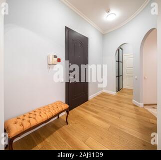 Modern interior of entrance hall in luxury apartment. Archs in the wall. Stock Photo