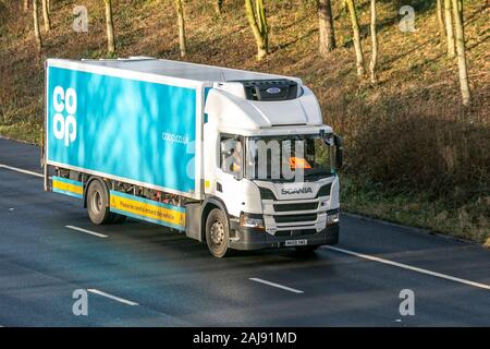 Coop deliver; Motorway heavy bulk Haulage delivery trucks, haulage, lorry, transportation, truck, special cargo, Scania vehicle, delivery, transport, industry, freight on the M55 at Blackpool, UK Stock Photo