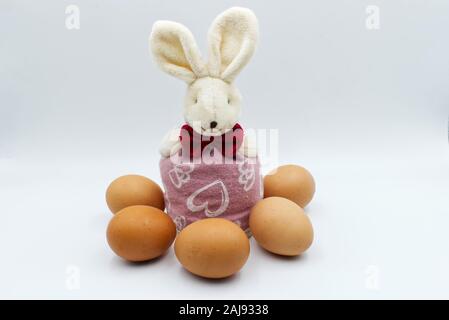 Easter rabbit with eggs isolated on white background. Traditional easter decoration Stock Photo