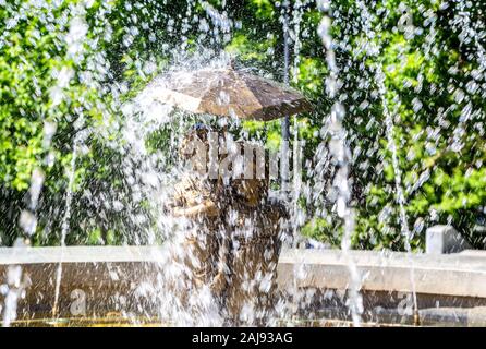 Samara, Russia - May 25, 2019: Sculpture at the fountain in the city park M. Gorky in a spray of water