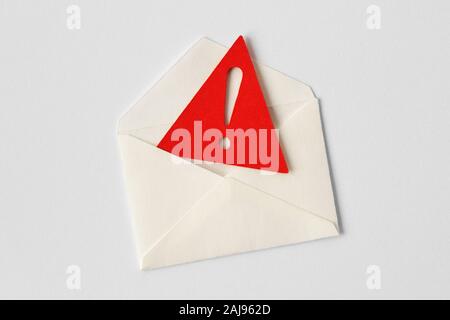 Email envelope with warning sign on white background Stock Photo