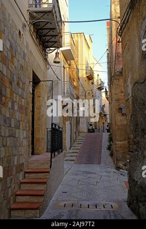 Narrow footpath cobblestone street in Sciacca, Province of Agrigento, Sicily, Italy. Stock Photo