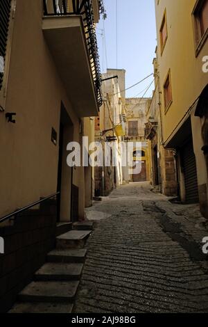 Narrow footpath cobblestone street in Sciacca, Province of Agrigento, Sicily, Italy. Stock Photo