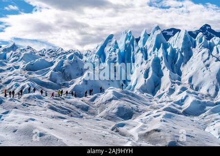 Tourists trekking on the famous Perito Moreno Glacier near El Calafate in Argentina, Patagonia, South America.