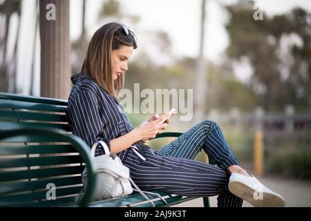 LOS ANGELES, CA - JUNE 12:  Alessandra Ambrosio is wearing a blue jumpsuit from Anthony Vaccarello and a white leather bag in the streets of LA. Stock Photo