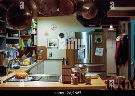 A Kitchen in a Rustic Home with Hanging Pots and Pans Stock Photo