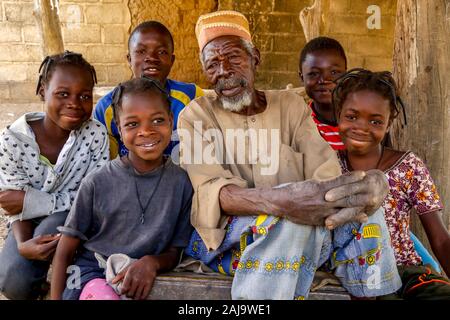 Children around their grandfather in tenkodogo, burkina faso Stock Photo