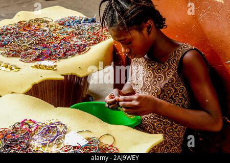 Girl making and selling jewelry in ouagadougou, burkina faso Stock Photo