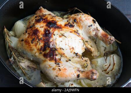 Tuscan Roast Chicken with Rosemary and Onions: A whole chicken roasted with garlic, onions, and rosemary in a white wine sauce Stock Photo