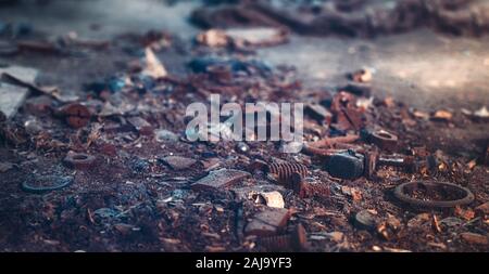 screws and nuts left on the floor in the abandoned factory Stock Photo