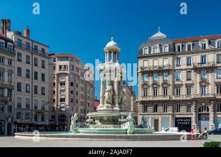 Lyon, France - July 19, 2018: Tourists visiting the jacobins square in the vieux lyon district and the beautiful fountain in the center. Stock Photo