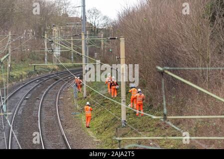 RailScape workers cutting back vegetation close to the track of the C2C railway in Southend on Sea, Essex, UK. Permanent way Stock Photo