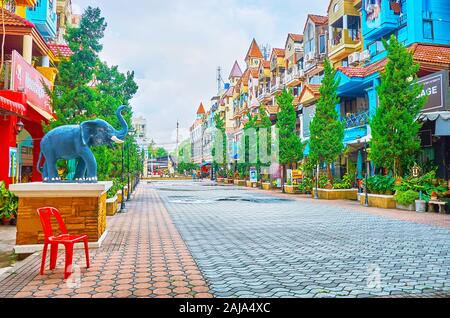 PATONG, THAILAND - APRIL 30, 2019: The quiet tourist street in Kathu District with many food stores, cafes, massage salons and hotels, on April 30 in Stock Photo