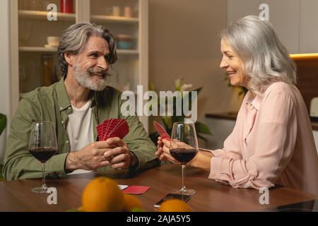 Woman holding playing cards with both hands Stock Photo