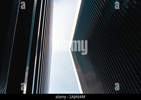 Corners of two contiguous buildings of modern architecture looking up at the sky Stock Photo