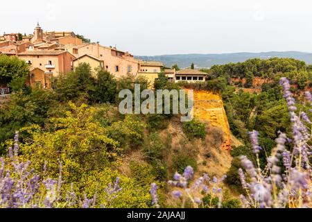 Ochre Trail in Roussillon, Sentier des Ocres, hiking path in a natural colorful area of red and yellow cliffs in a disused ocher pigment quarry surrou Stock Photo