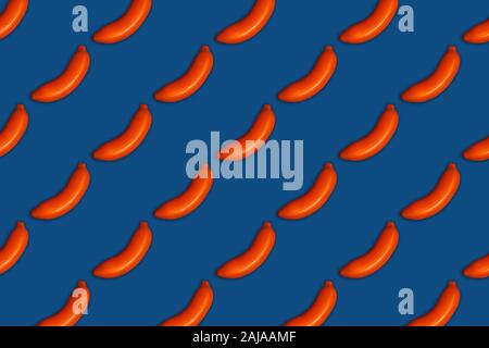 Classic blue food pattern of painted orange bananas. Flat lay, top view.