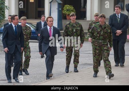 California Governor Arnold Schwarzenegger and Prime Minister David Cameron with British troops from the 1st Battalion the Grenadier Guards at the Wellington Barracks in London. Stock Photo