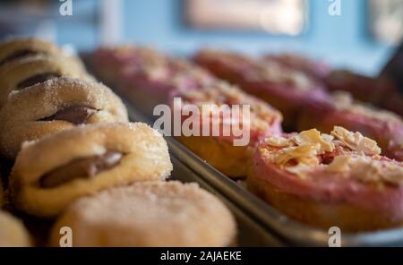 Two Trays of Donuts Featuring Filling and Flakes Stock Photo