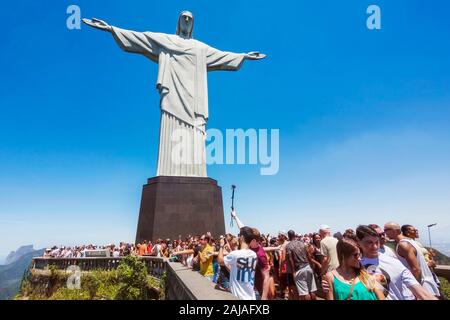 Tourists at the Christ the Redeemer statue atop the Corcovado Mountain in Rio de Janeiro, Brazil.