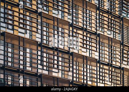 Geometric facade of a minimalist building under the last afternoon lights. Stock Photo