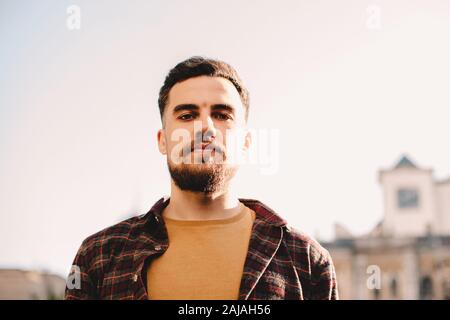Portrait of young hipster man against clear sky in city Stock Photo