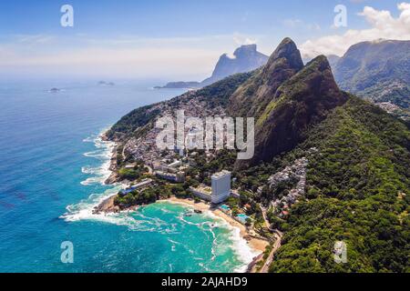 Rio de Janeiro, Brazil, aerial view of Two Brothers mountain (Portuguese: Morro Dois Irmaos) and Favela Vidigal in the summer, daytime. Stock Photo