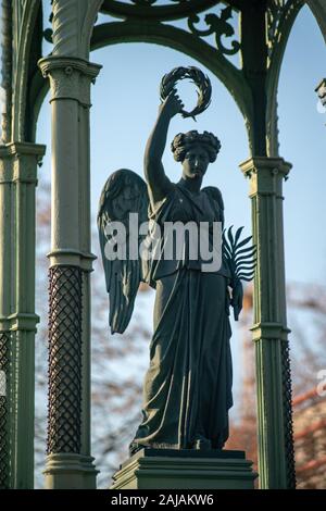 Detailed stone statue of an angel on a german graveyard in Berlin on a sunny bright winter day Stock Photo
