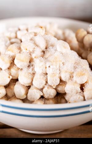 Frozen chickpeas in bowl on wooden background. Stock Photo