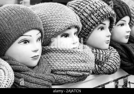 Mannequins female heads in hats and scarfs close up. Woolen knitted caps and scarves. Female headdresses Stock Photo