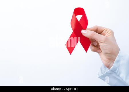 The red ribbon is a symbol of the fight against AIDS. Stock Photo
