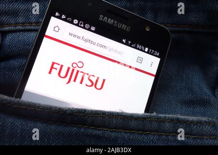 Fujitsu website displayed on Samsung smartphone hidden in jeans pocket Stock Photo