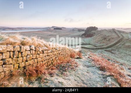 Hotbank Crags and Housestead Crags on Hadrian's Wall, the edge of the Roman Empire, in Northumberland on a cold and frosty winter morning. Stock Photo