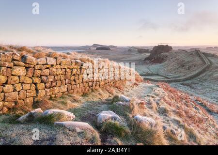 Hotbank Crags and Housestead Crags on Hadrian's Wall, the edge of the Roman Empire, in Northumberland on a cold and frosty winter morning. Stock Photo