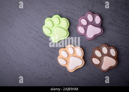 Cute colored paw shape soap on dark dark background Stock Photo