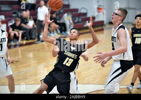 Focused on a rebound,a player looked to secure the ball in front of two opponents. USA. Stock Photo