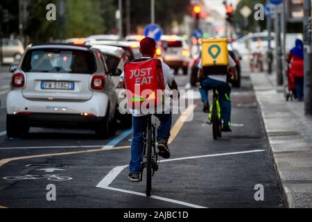 Turin, Italy - 30 July, 2019: A Just Eat and a Glovo couriers ride during his work. Just Eat and Glovo are a online food delivery apps (as Uber Eats and Foodora) that hires food riders as independent contractors. Credit: Nicolò Campo/Alamy Live News Stock Photo