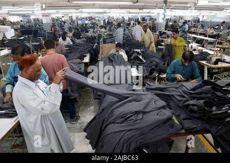 Karachi. 27th Nov, 2019. Laborers work in a garment factory in southern Pakistani port city of Karachi on Nov. 27, 2019. According to the Pakistani government, the textile industry contributes nearly 60 percent to the country's total exports, rendering it the major industrial sector of Pakistan which plays an important role in the economic growth of the country. TO GO WITH 'Spotlight: Pakistani industrialists envisage Chinese collaboration to modernize growing textile industry, boost export' Credit: Str/Xinhua/Alamy Live News