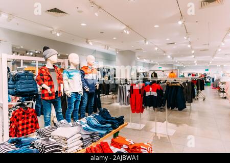 Mannequins Dressed In Children Male Man Casual Clothes And Colorful Bright Children Clothes On Shelves And Hanger In Store Of Shopping Center. Stock Photo