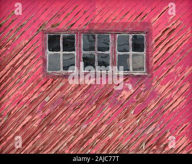 Weathered wooden red garage door with peeling paint in Alamogordo, New Mexico Stock Photo