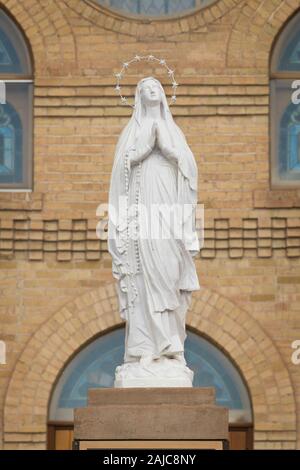 Virgin Mary statue in front of the Basilica San Albino Catholic Church on Calle Principal in the historic district of Mesilla, New Mexico Stock Photo