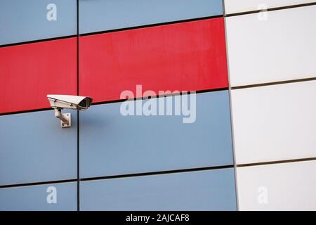 Outdoor surveillance camera on colored building facade Stock Photo