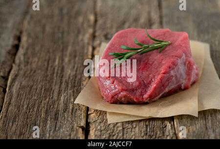 raw steak on wooden surface Stock Photo