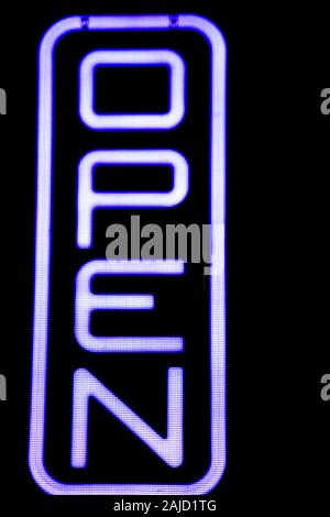 Open neon sign at the door of a pub Stock Photo