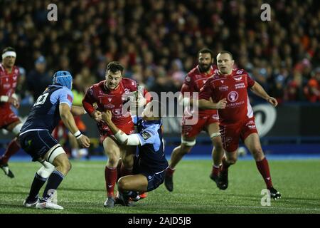 Cardiff, UK. 03rd Jan, 2020. Ryan Conbeer of the Scarlets is tackled. Guinness Pro14 rugby match, Cardiff Blues v Scarlets at the BT Sport Cardiff Arms Park in Cardiff on Friday 3rd January 2020. this image may only be used for Editorial purposes. Editorial use only. pic by Andrew Orchard/Andrew Orchard sports photography/Alamy Live news Credit: Andrew Orchard sports photography/Alamy Live News Stock Photo