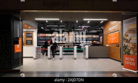 A woman exits an Amazon Go store inside Rockefeller Center in Manhattan, New York, NY. Amazon go stores are cashier-less, cash-free convenience stores Stock Photo