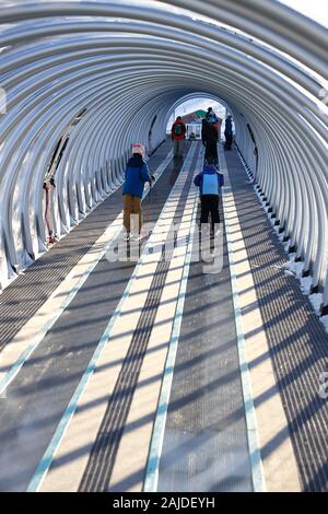 Skiers on a covered magic carpet on the learner's slope aka Bunny slope at Mont-Orford Ski Resort. Mont-Orford National Park.Orford.Quebec.Canada Stock Photo